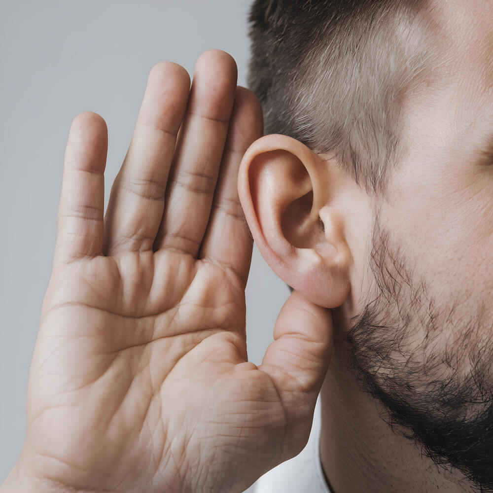 Mans hand near ear indicating attentive listening emphasizing communication